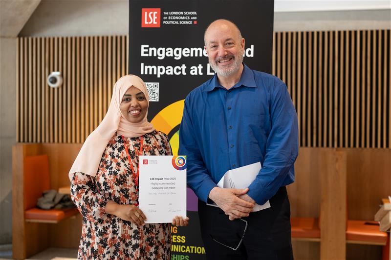 LSE Vice Chancellor Professor Larry Kramer presents the Highly Commended Outstanding Team Impact Award to Dr Souad Mohamed and partners for advancing women’s leadership and resilience.