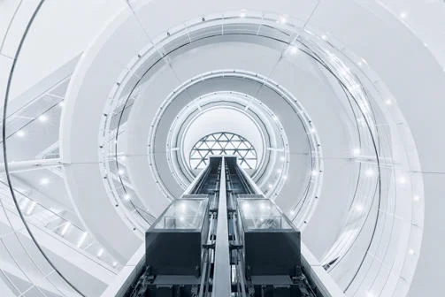 A view of LSE Library staircase and lifts from below