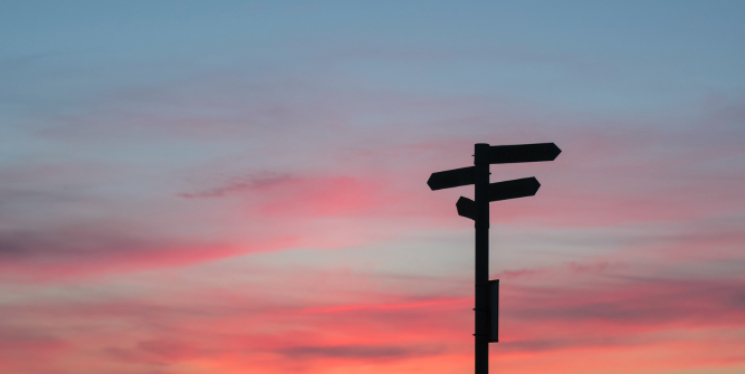 Silhouette of a direction board at evening