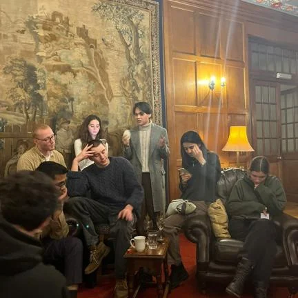 LSE Philosophy students sitting and talking to each other inside the Cumberland Lodge.