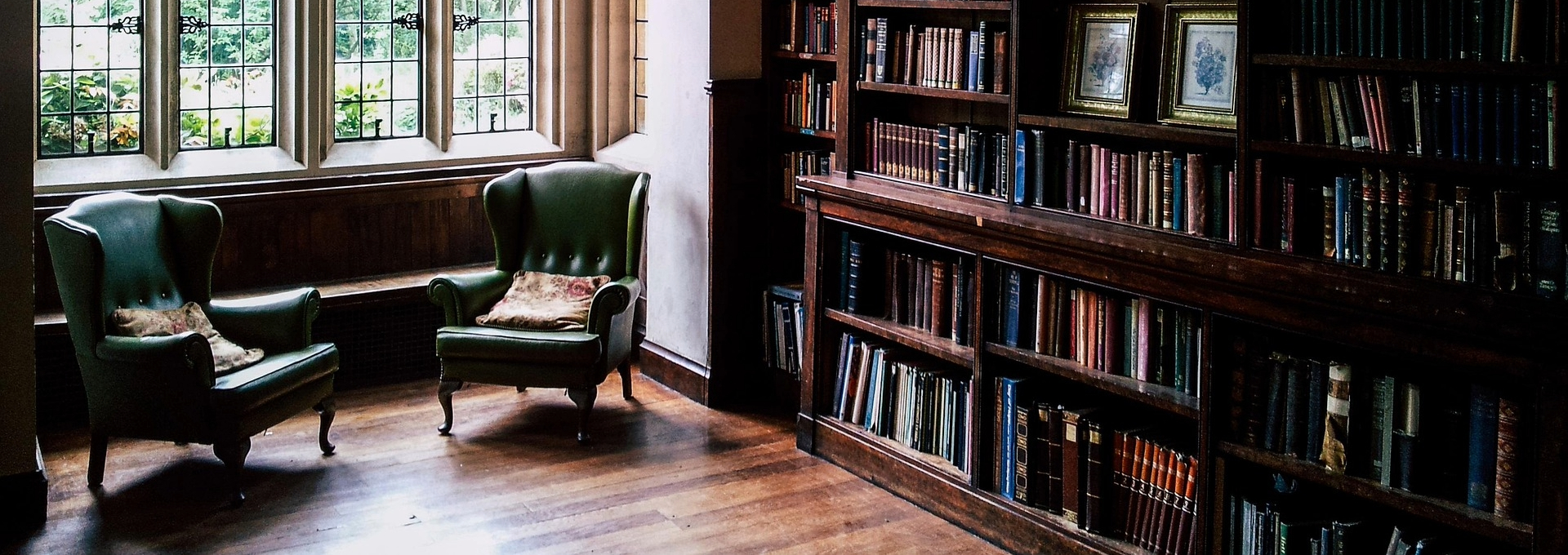 Two chairs next to a book shelf
