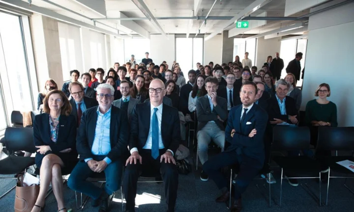Roland Lescure sitting surrounded by LSE faculty and students