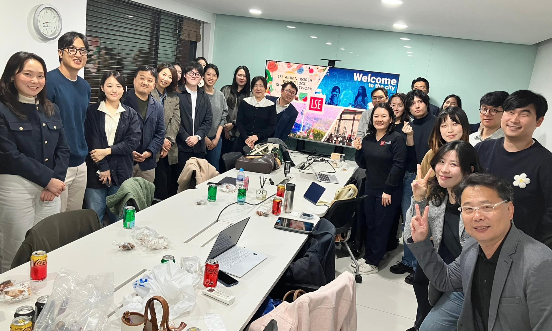 Alumni gather around a table during a knowledge exchange for Welcome to the City in Seoul