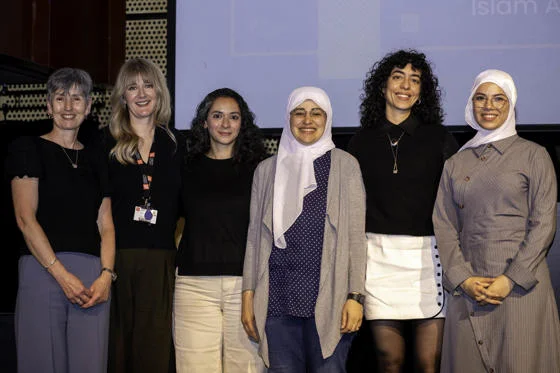 a group photo of methodology academics standing on stage