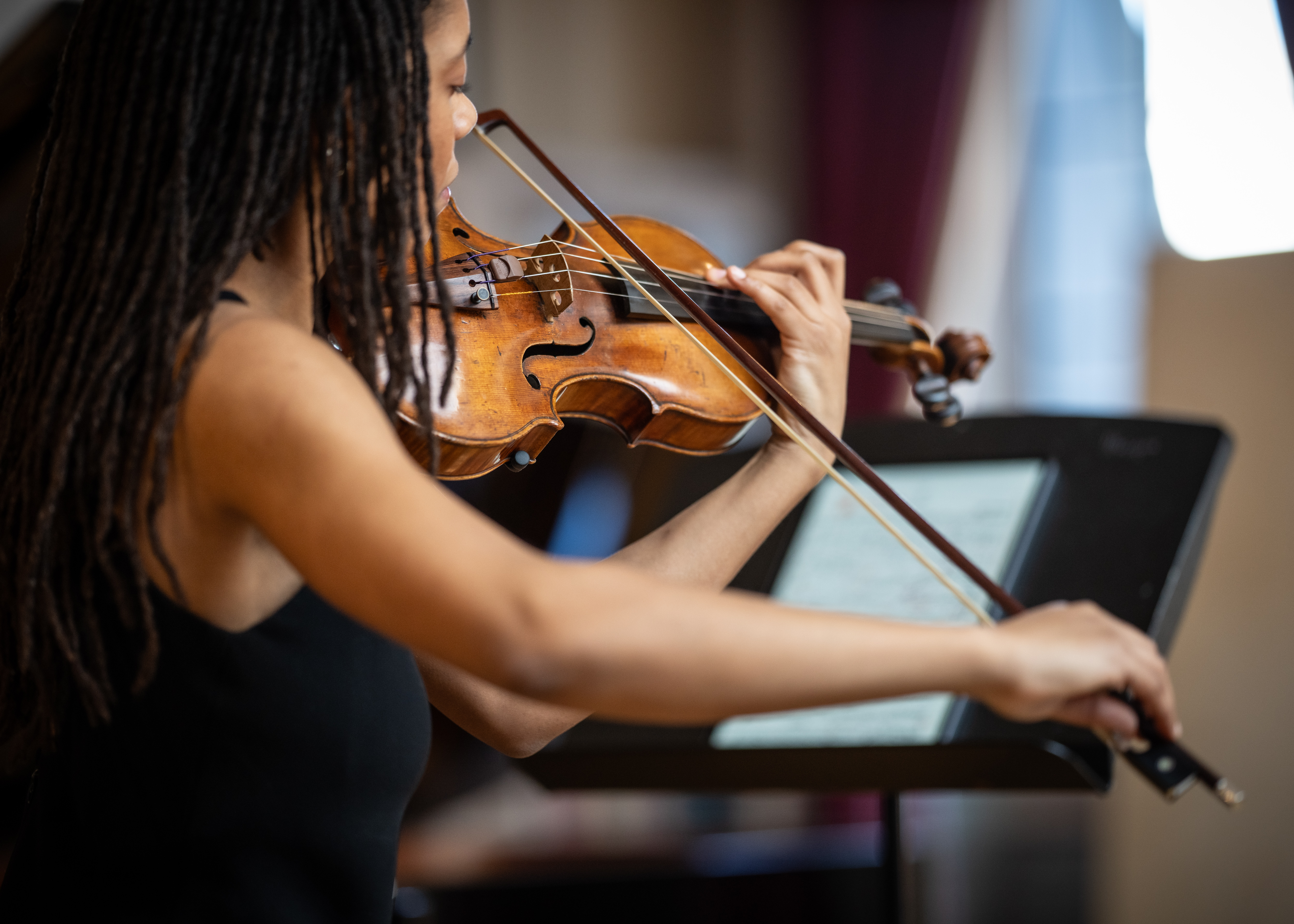 A violinist performing at a lunchtime concert.