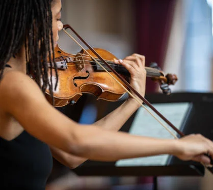 A violinist performing at a lunchtime concert.