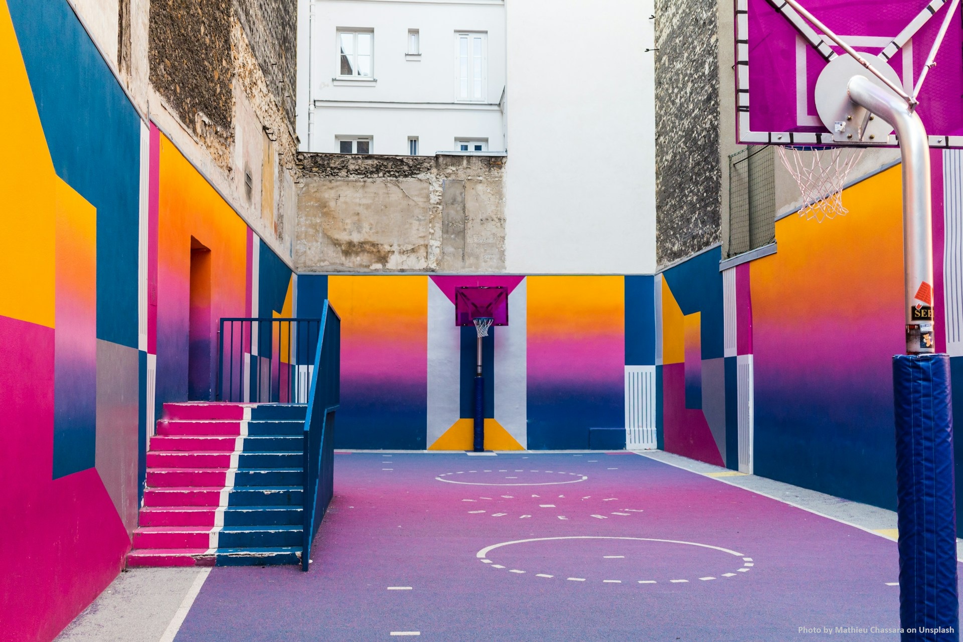 Colorful photo of a basketball court in Duperré, in Paris.