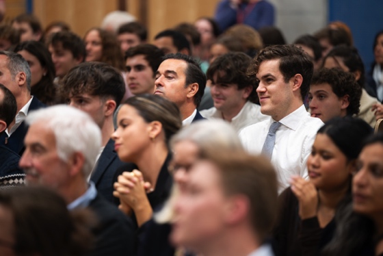 Audience seated in a lecture hall, attentively listening to a speaker during an LSE event.
