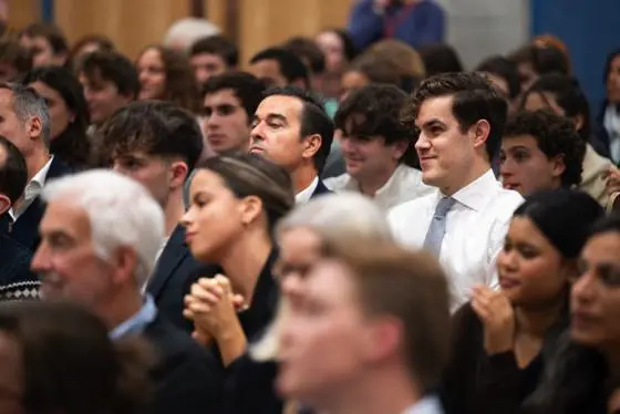 Audience seated in a lecture hall, attentively listening to a speaker during an LSE event.