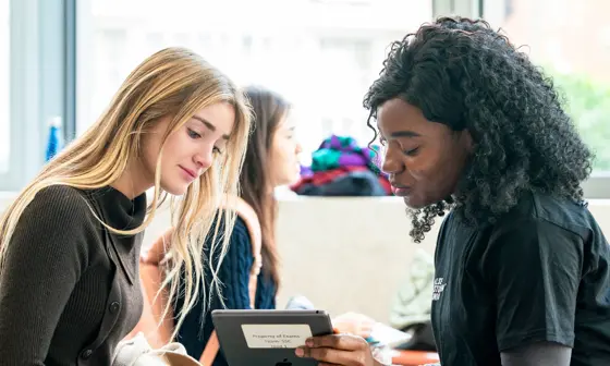 Two people looking at an iPad