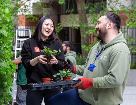 Student and staff on LSE rooftop gardening