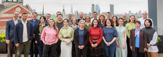 a group photo of the department of methodology, standing in front of the london skyline