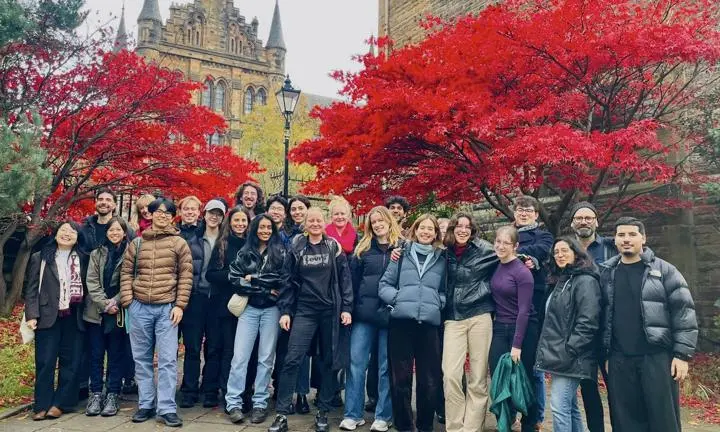 MSc City Design and Social Science students in Glasgow under a red leaf tree.