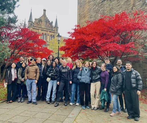 MSc City Design and Social Science students in Glasgow under a red leaf tree.