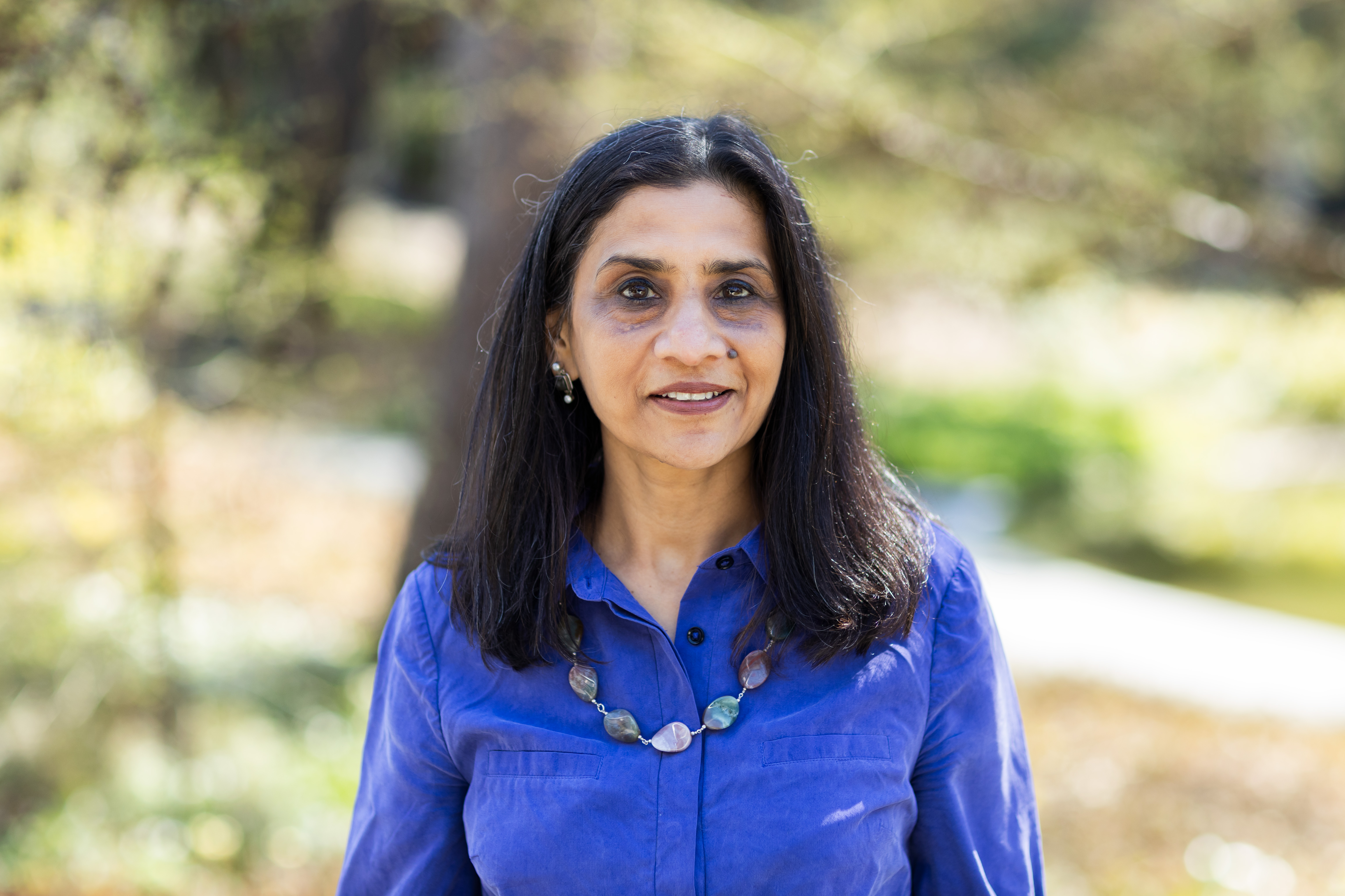 headshot of a woman in a blue shirt