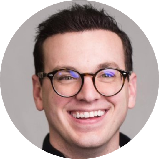 Image of a Nathaniel Schermerhorn with glasses and smiling.  Nathanial has short black hair.