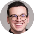 Image of a Nathaniel Schermerhorn with glasses and smiling. Nathanial has short black hair.