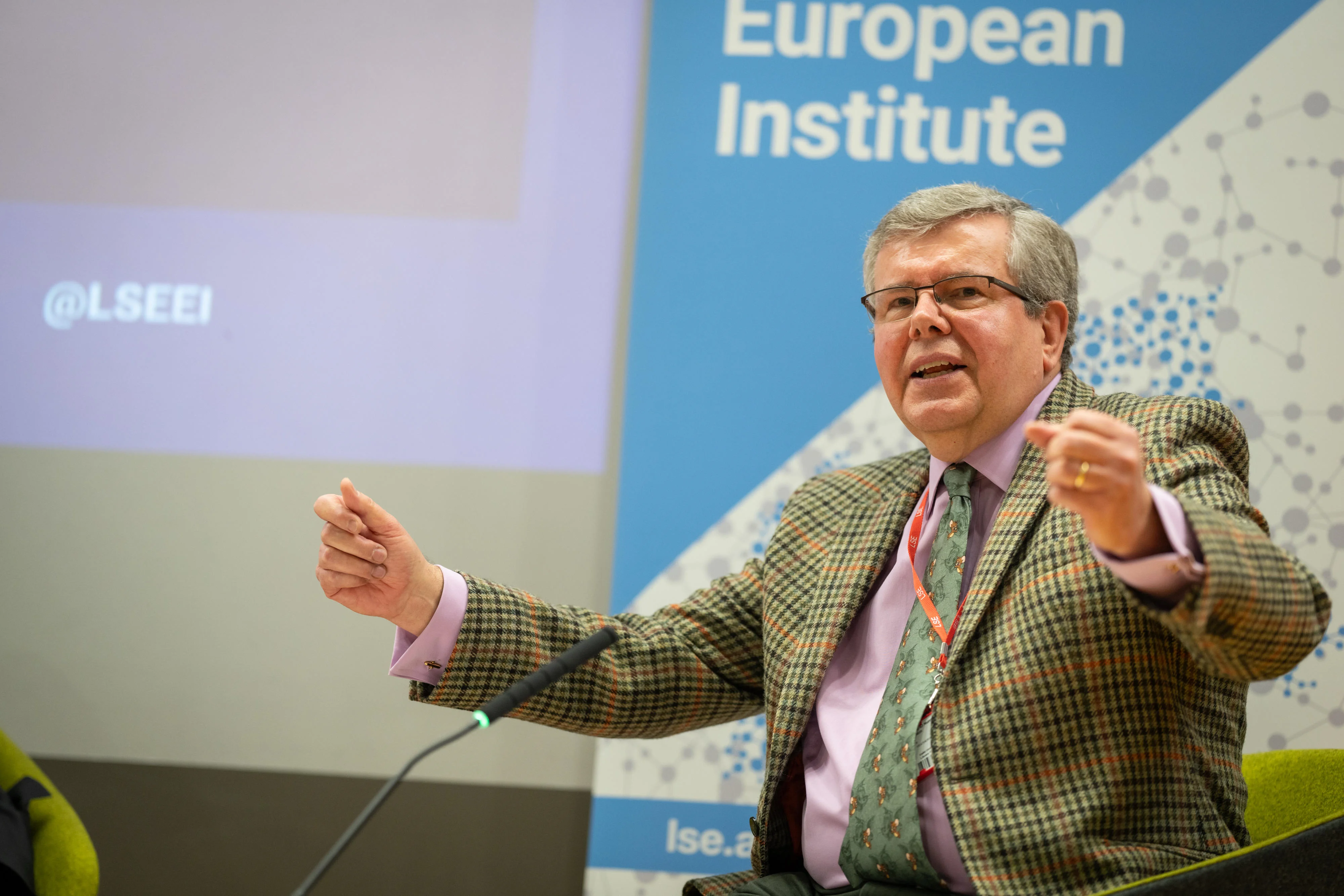 man with hands in the air on chair