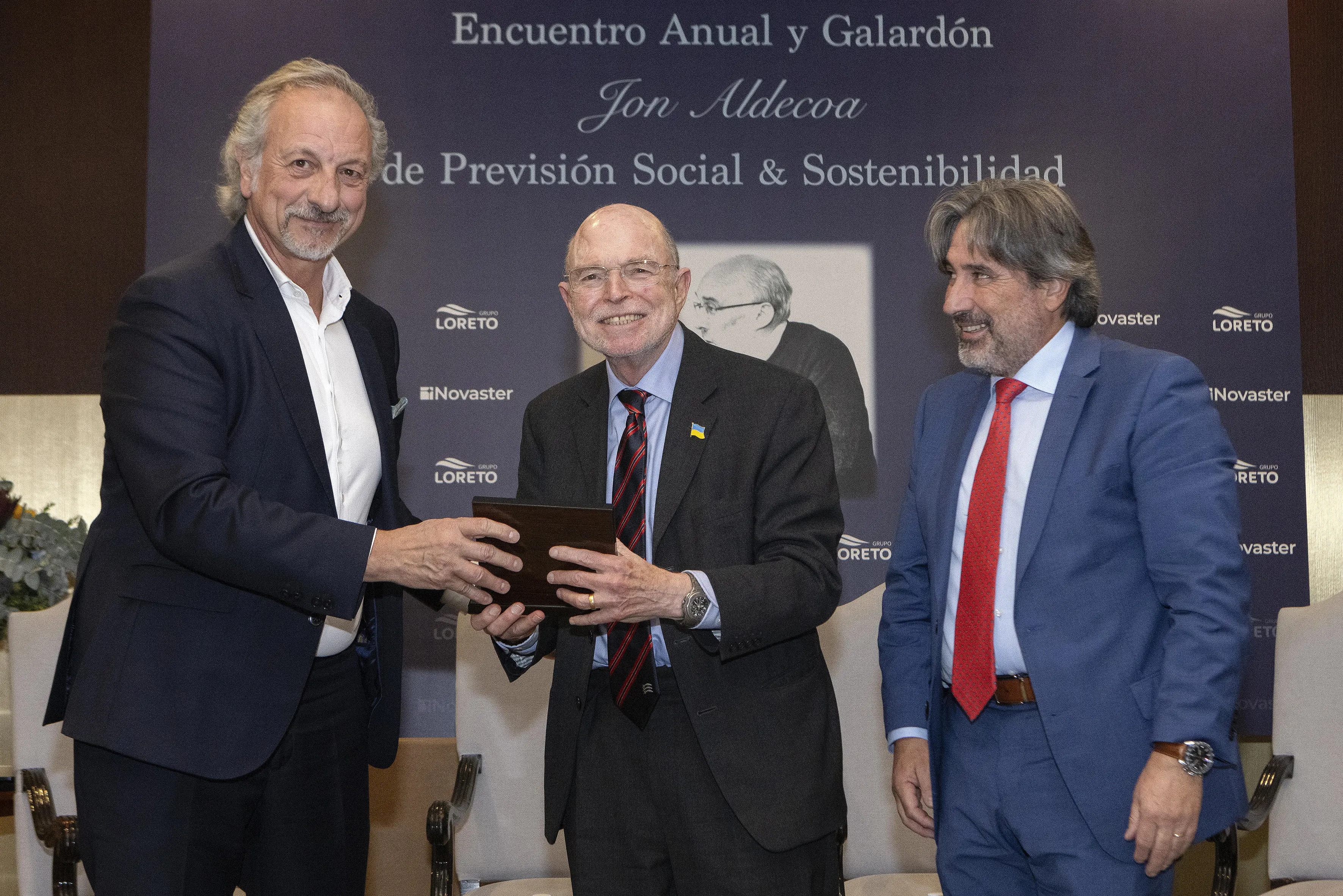 Nick Barr receiving award with two other men