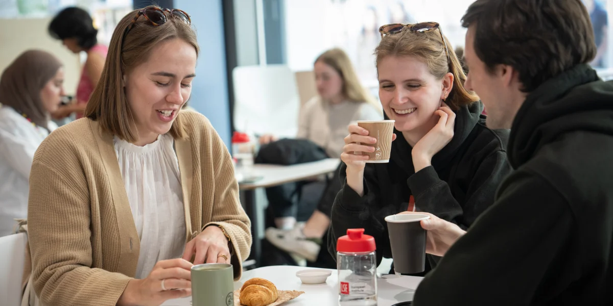 Students having coffee around a table