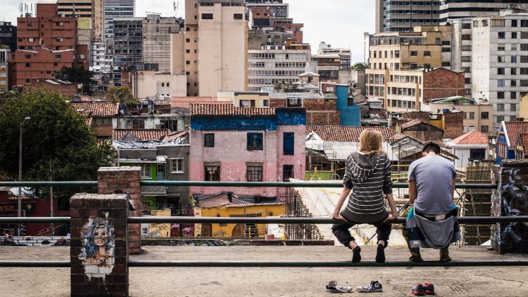 Two people looking at a developing city skyline