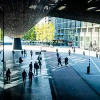 City street with bridge and pedestrians