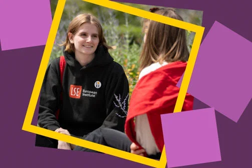 Woman smiling wearing an LSE EI hoodie