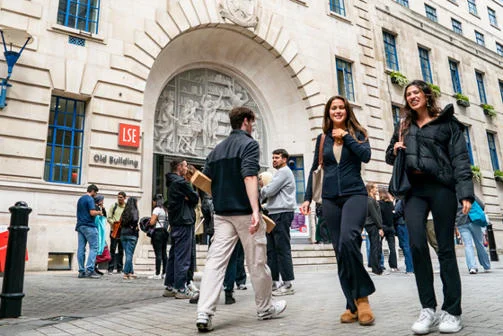 Students walk past the main entrance to LSE's Old Building