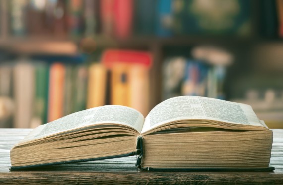 Open book with shelves behind (istock)