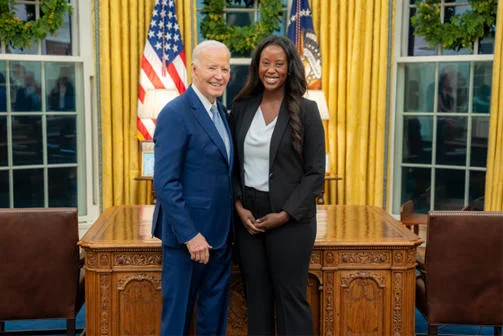 Oumou Ly stands with former President Biden in the White House