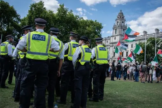 Police officers by Palestine protesters