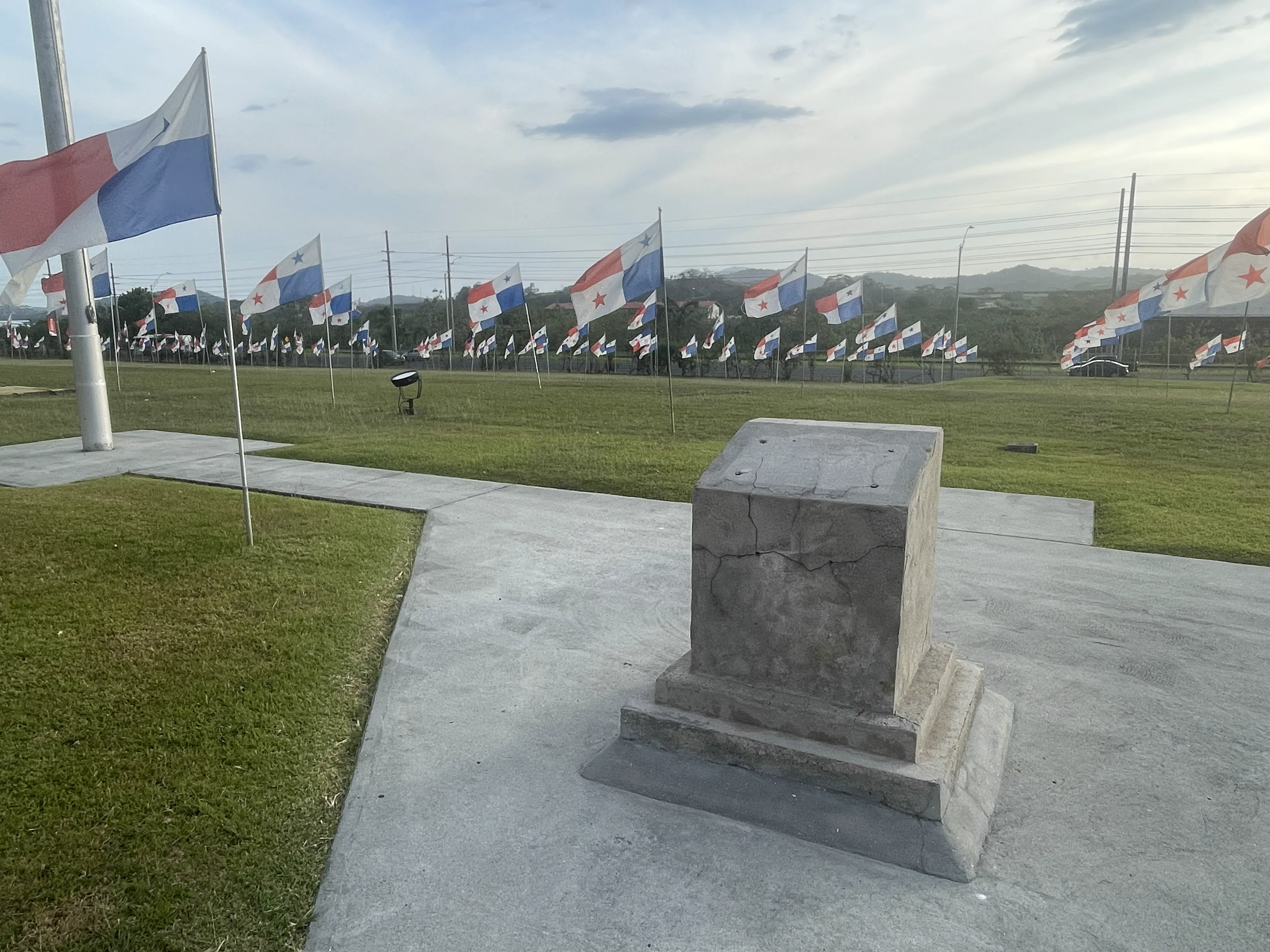 A pedestal representing the Panama city of knowledge, with some panamanian flags and the canal.