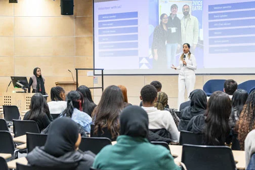 WP Pathways to Law participants sitting in a lecture theatre listing to a speaker on stage