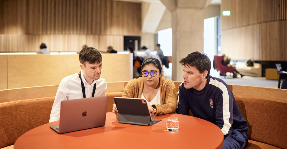 Three EMSBE students sitting together and looking into their laptops