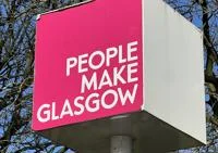 "People make Glasgow" slogan on a sign with a pink background