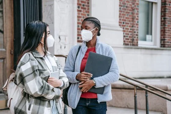 Two women wearing facemasks.