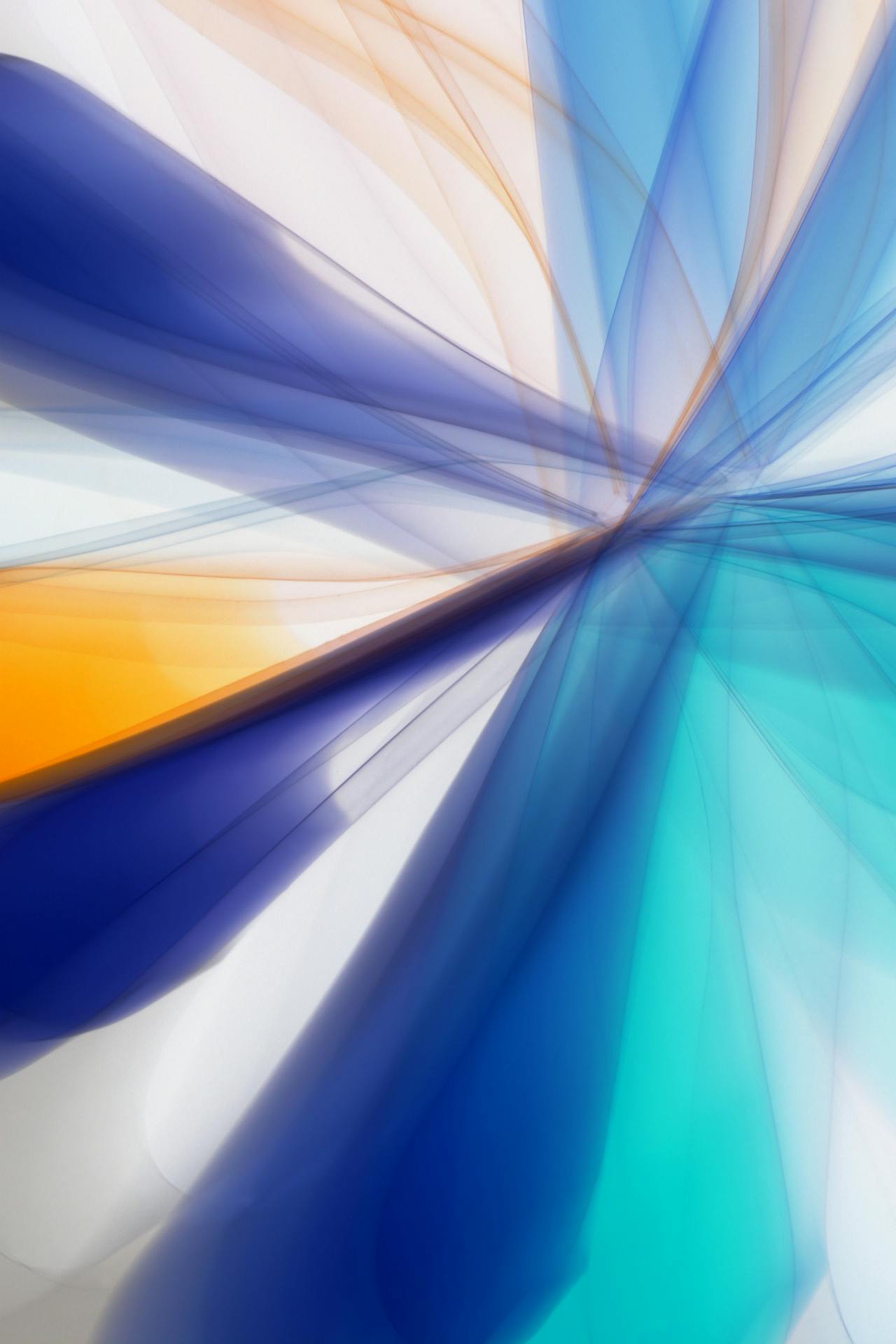 Abstract image of blue, teal, white, and yellow streaks radiating into a motion-blur effect. 