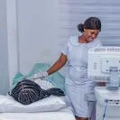 Healthcare staff operating an ultrasound on a patient