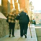 Two elderly people walking side by side