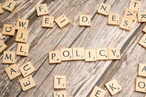 Scrabble letters, spelling out 'policy'