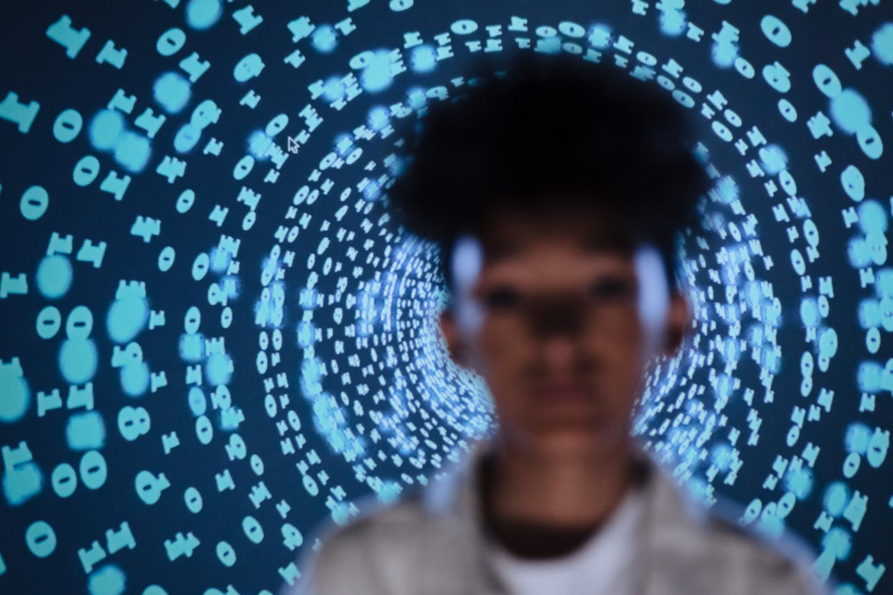 Blurred figure standing before a circular pattern of glowing binary code numbers