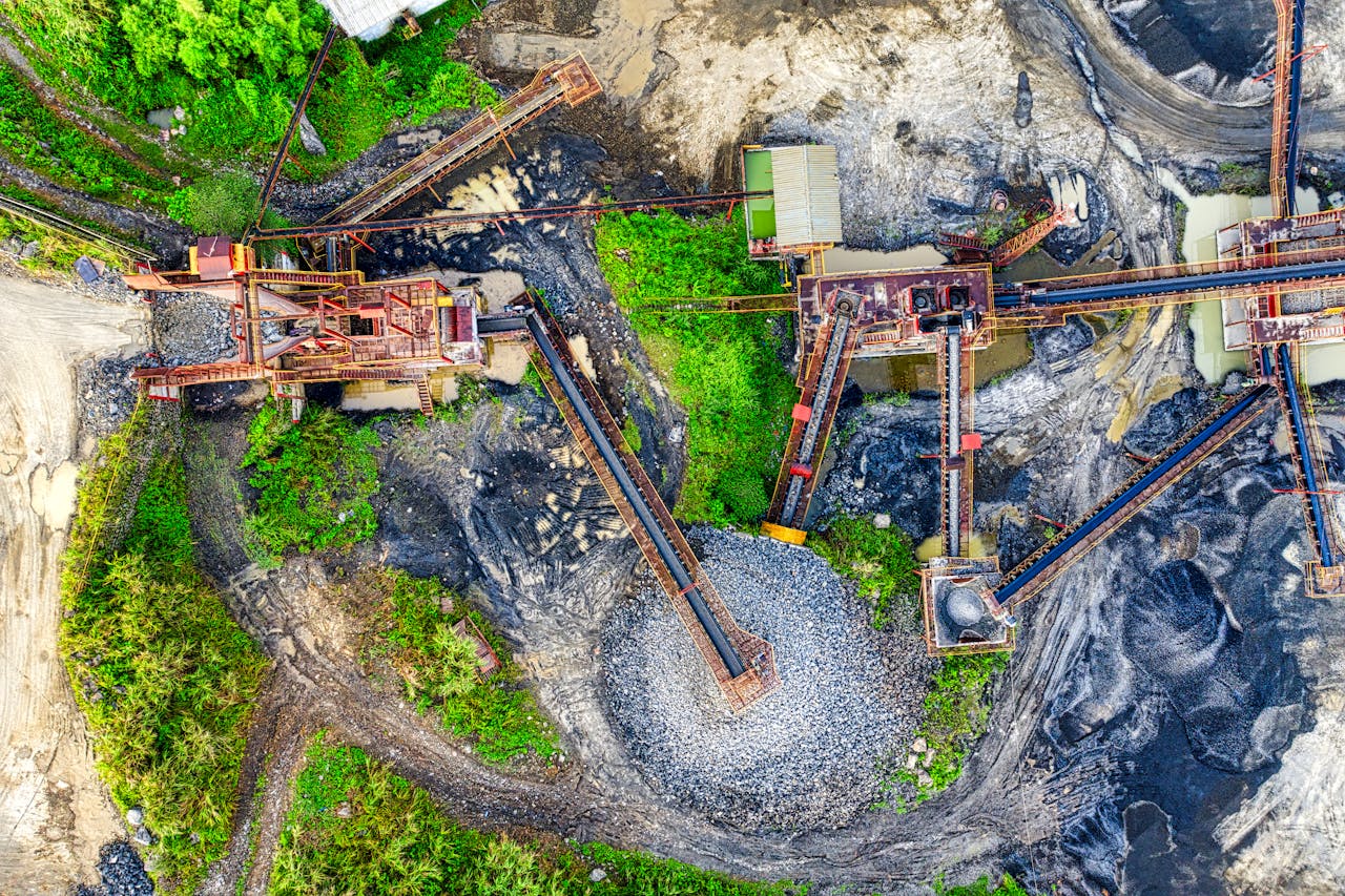 Top-down view of a quarry site showing conveyor systems moving gravel