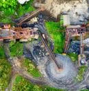 Top-down view of a quarry site showing conveyor systems moving gravel