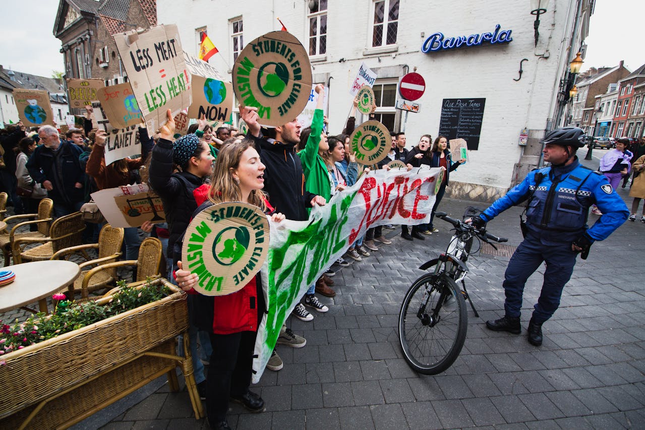 Climate activists hold signs during a street protest calling for urgent environmental action.