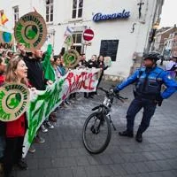 Climate activists hold signs during a street protest calling for urgent environmental action.