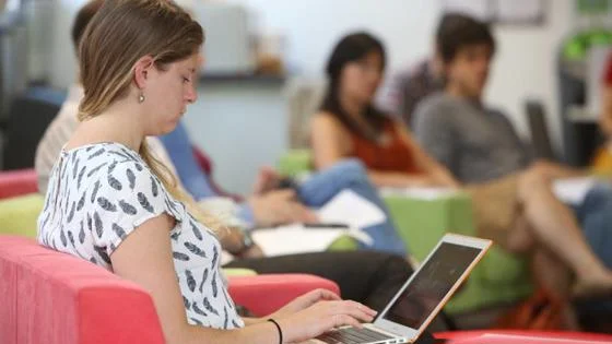 Student in PhD Academy typing on laptop