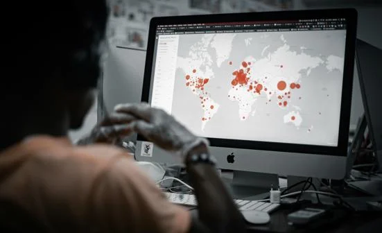 Someone looking at a disease map on a PC