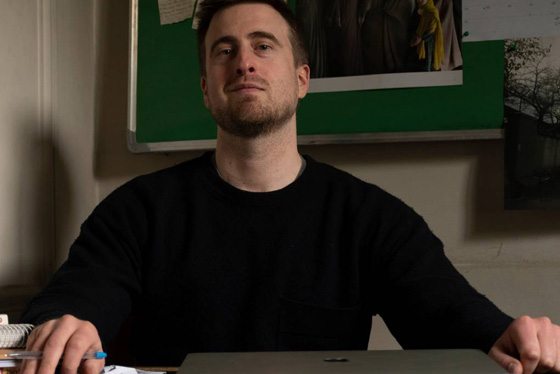 Phillip Wellman sits at a desk