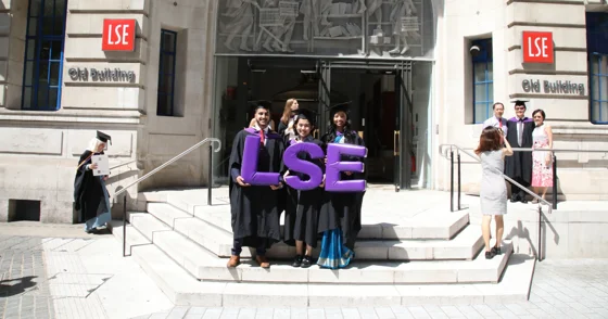 Graduates holding an LSE sign