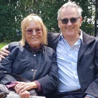 Phoebe and Tony Hall sit on a bench in Lincoln Inn Fields